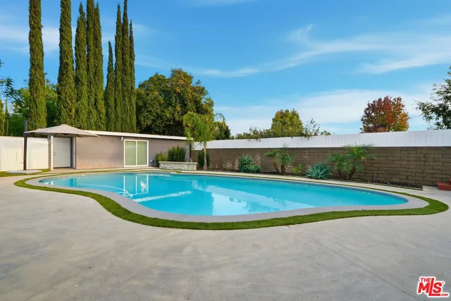 a view of a swimming pool with a yard