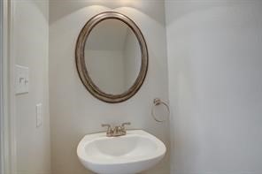 1304 Robin Street Houston, TX 77019 - Photo 10 of 11 Conveniently located. half bath with pedestal sink & framed mirror