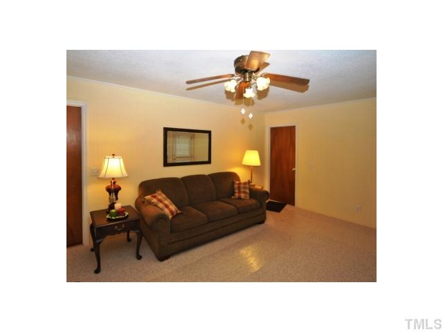 4801 Will-O-Dean Road Raleigh, NC 27616 - Photo 14 of 23 a living room with furniture and a lamp