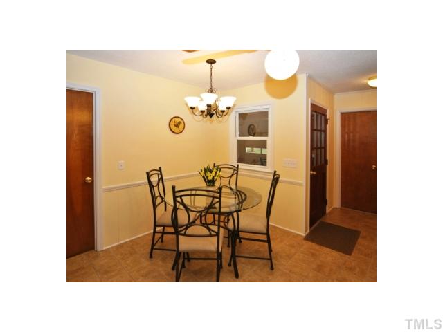 4801 Will-O-Dean Road Raleigh, NC 27616 - Photo 7 of 23 a dining room with a table and chairs