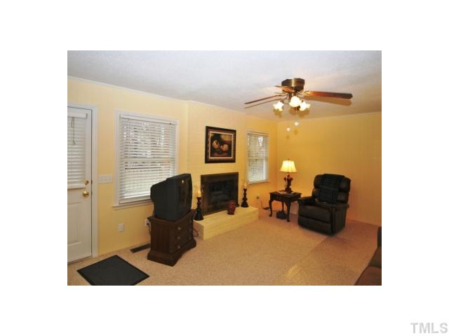 4801 Will-O-Dean Road Raleigh, NC 27616 - Photo 10 of 23 a living room with furniture potted plant and a lamp