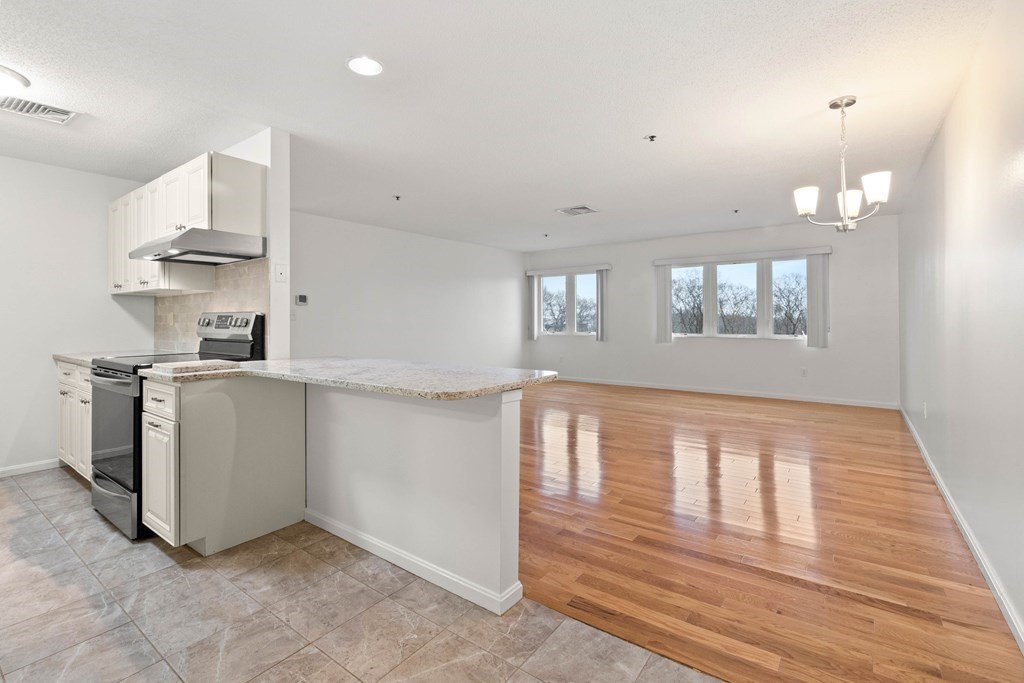 36 Dunham Road, Unit 306 Beverly, MA 01915 - Photo 11 of 26 a view of a kitchen with furniture and wooden floor