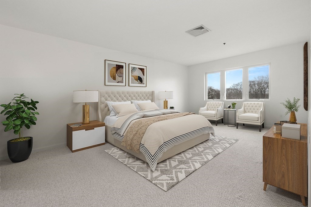 36 Dunham Road, Unit 306 Beverly, MA 01915 - Photo 12 of 26 a spacious bedroom with a bed and a couch