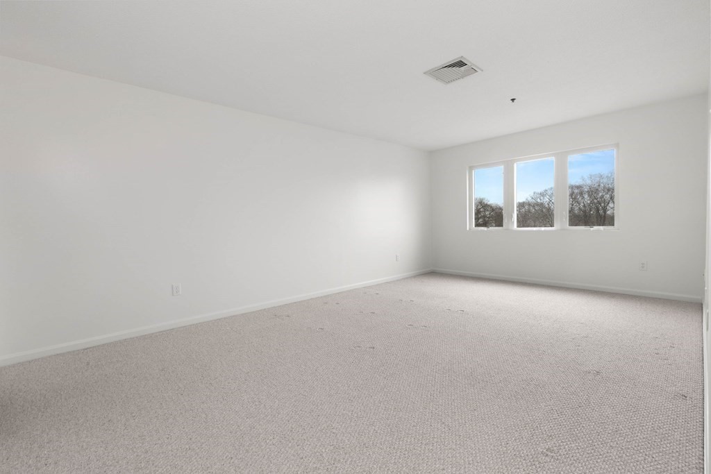 36 Dunham Road, Unit 306 Beverly, MA 01915 - Photo 14 of 26 an empty room with windows