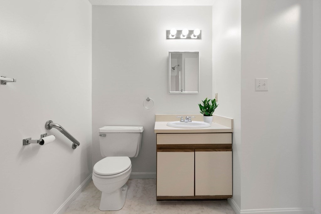 36 Dunham Road, Unit 306 Beverly, MA 01915 - Photo 17 of 26 a bathroom with a sink a toilet and mirror