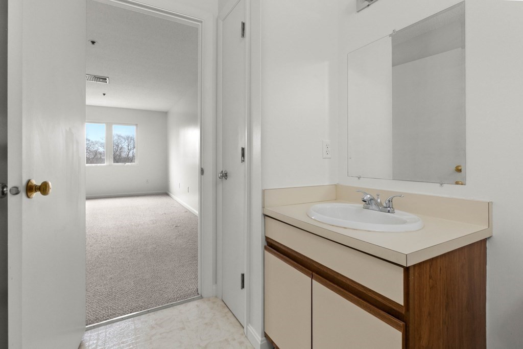 36 Dunham Road, Unit 306 Beverly, MA 01915 - Photo 19 of 26 a bathroom with a sink and a mirror