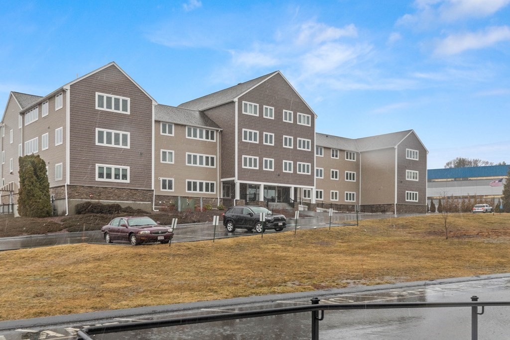 36 Dunham Road, Unit 306 Beverly, MA 01915 - Photo 26 of 26 a front view of residential houses with yard