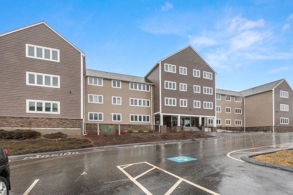 36 Dunham Road, Unit 306 Beverly, MA 01915 - Photo 5 of 26 a view of a building with a swimming pool