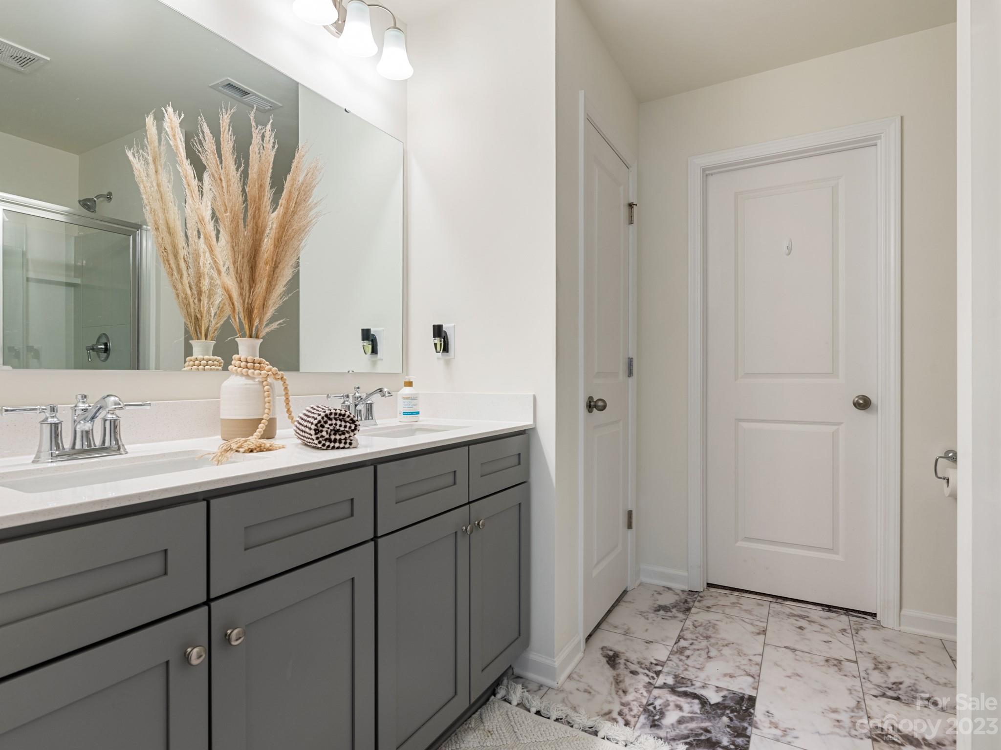 225 Quinn Road Matthews, NC 28104 - Photo 16 of 24 a bathroom with a sink and a mirror