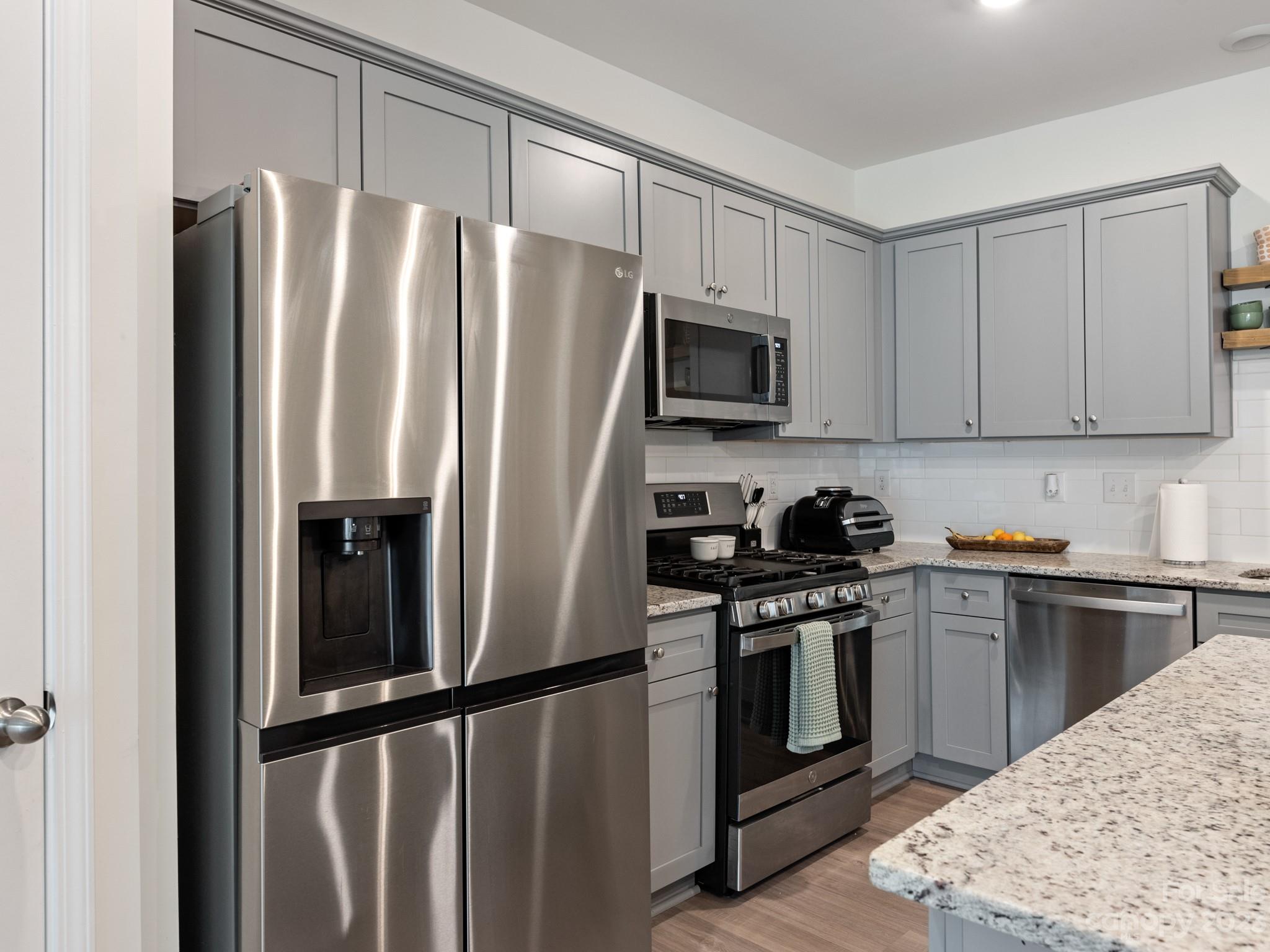 225 Quinn Road Matthews, NC 28104 - Photo 9 of 24 a kitchen with stainless steel appliances granite countertop a stove a refrigerator and a sink