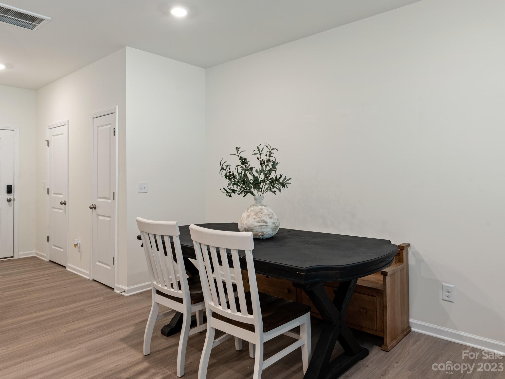 225 Quinn Road Matthews, NC 28104 - Photo 10 of 24 a view of a dining room with furniture and wooden floor