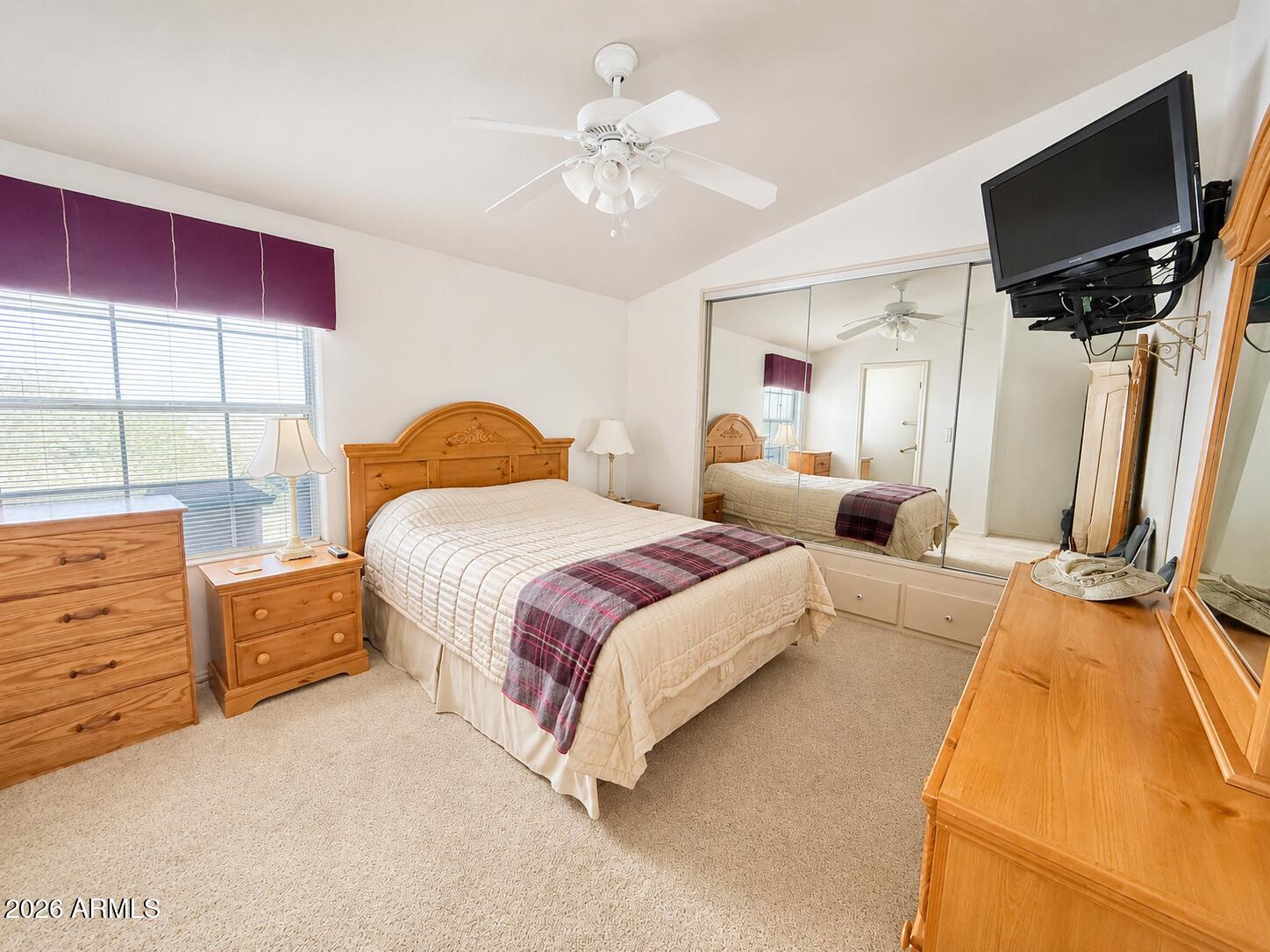 8865 East Baseline Road, Unit 103 Mesa, AZ 85209 - Photo 17 of 47 a bedroom with a bed and a flat screen tv