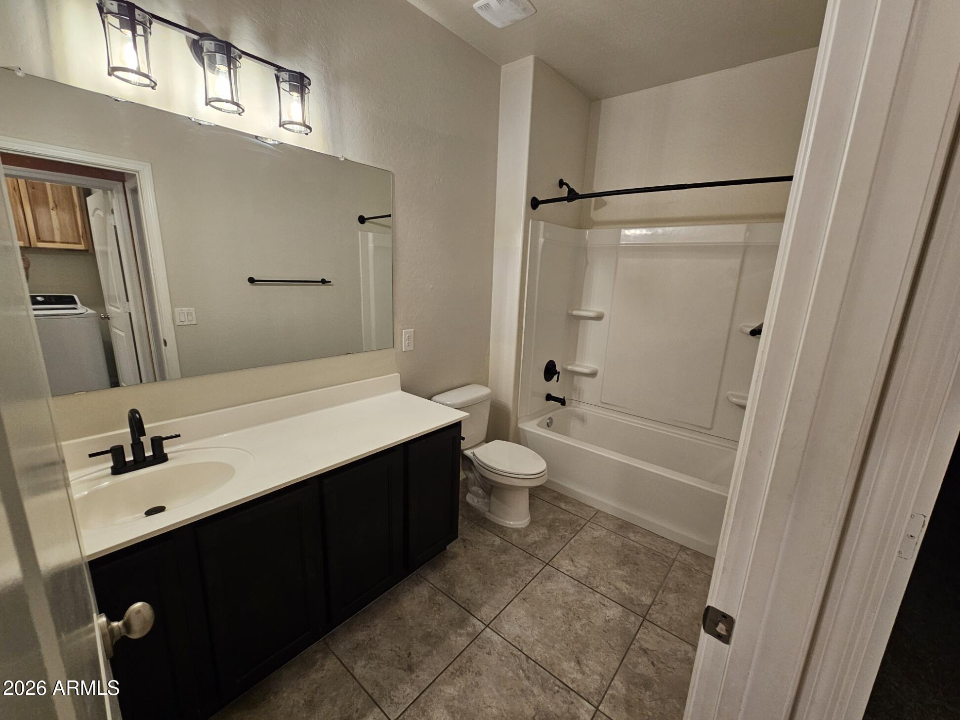 25573 West Coles Road Buckeye, AZ 85326 - Photo 12 of 12 a bathroom with a sink a toilet and shower