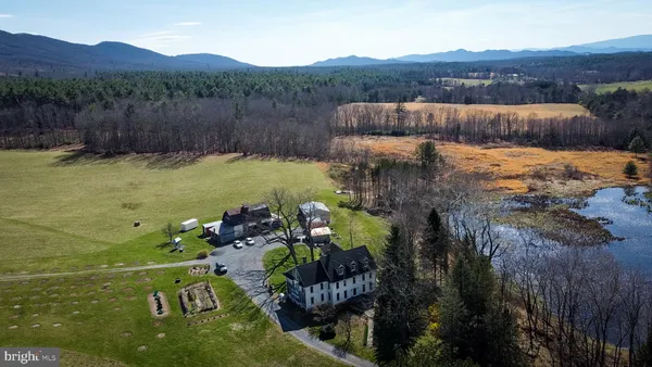 a view of a lush green hillside and houses