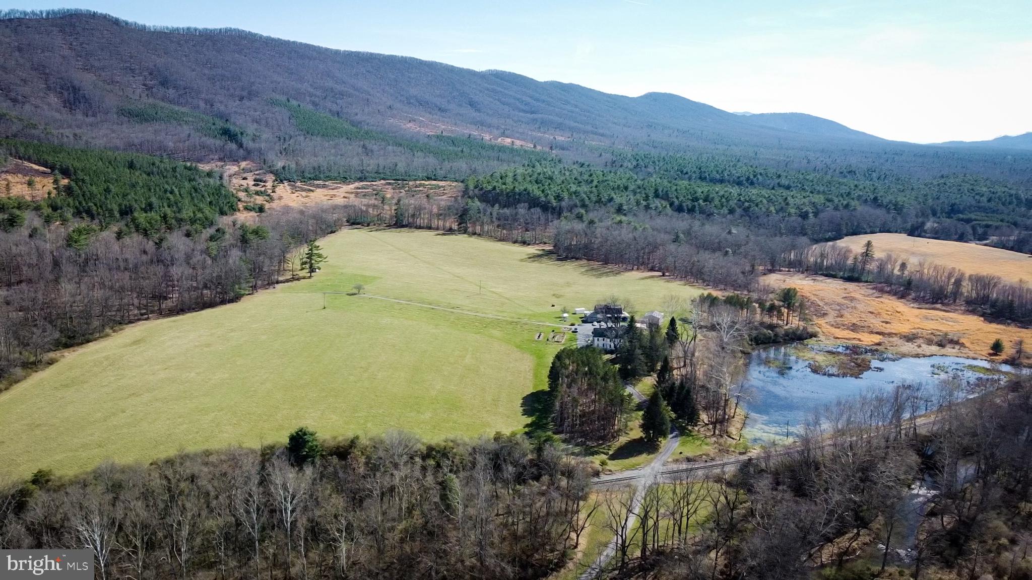 33940 Mountain Valley Road Millboro, VA 24460 - Photo 16 of 22 Expansive landscape meets serene mountains.