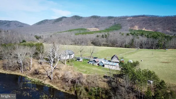a view of a lush green hillside and houses