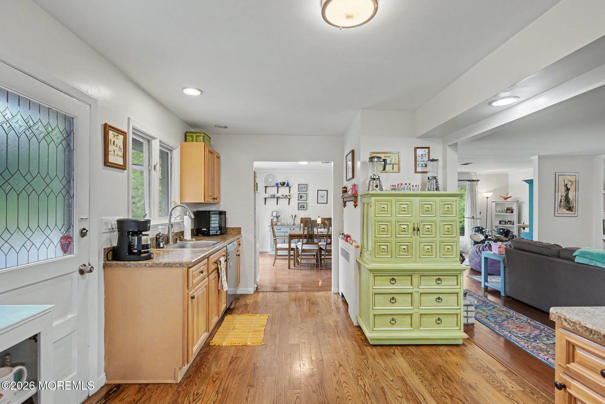 699 Aldrich Road Howell, NJ 07731 - Photo 9 of 30 a kitchen with a wooden floor and large windows