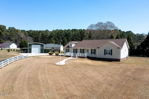an aerial view of a house with a yard