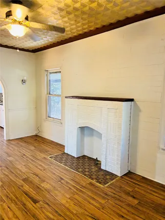 a view of water heater room with wooden floor