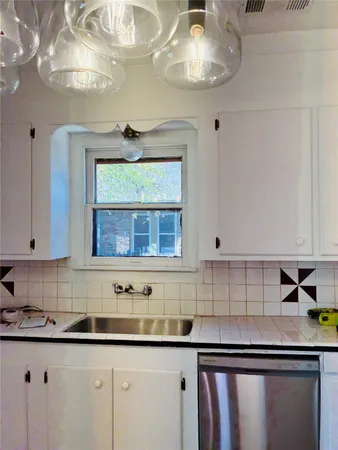 a kitchen with stainless steel appliances a sink a stove and cabinets