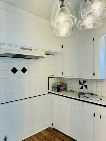 a kitchen with stainless steel appliances granite countertop a sink a stove and cabinets