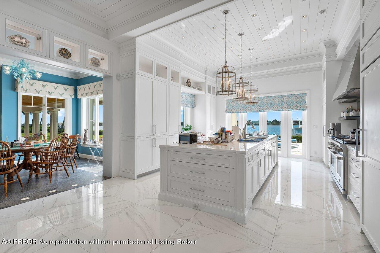 1275 Lands End Road Lake Worth, FL 33462 - Photo 16 of 83 a view of a dining room with furniture a chandelier and kitchen view