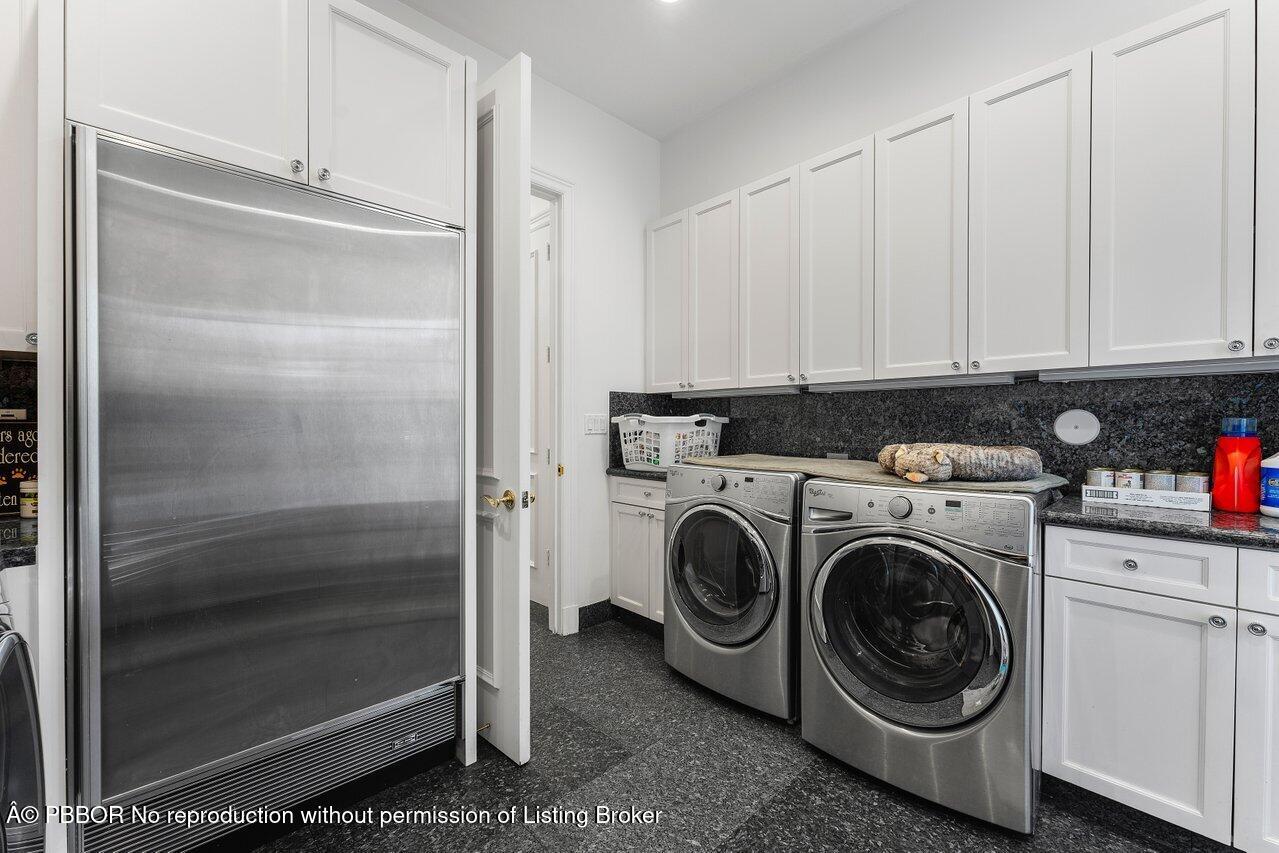 1275 Lands End Road Lake Worth, FL 33462 - Photo 27 of 83 a utility room with cabinets washer and dryer
