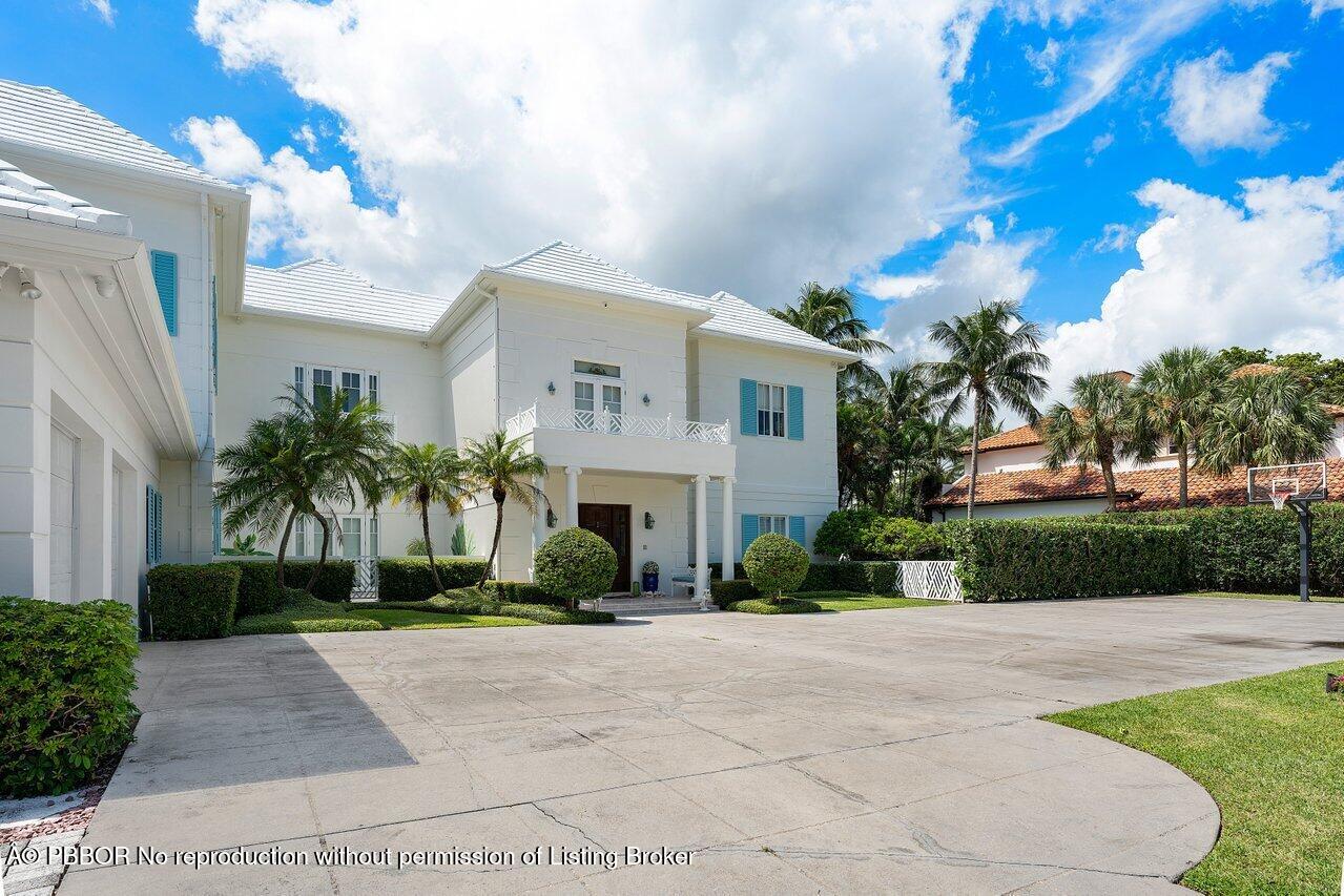 1275 Lands End Road Lake Worth, FL 33462 - Photo 4 of 83 a front view of a house with a yard and potted plants