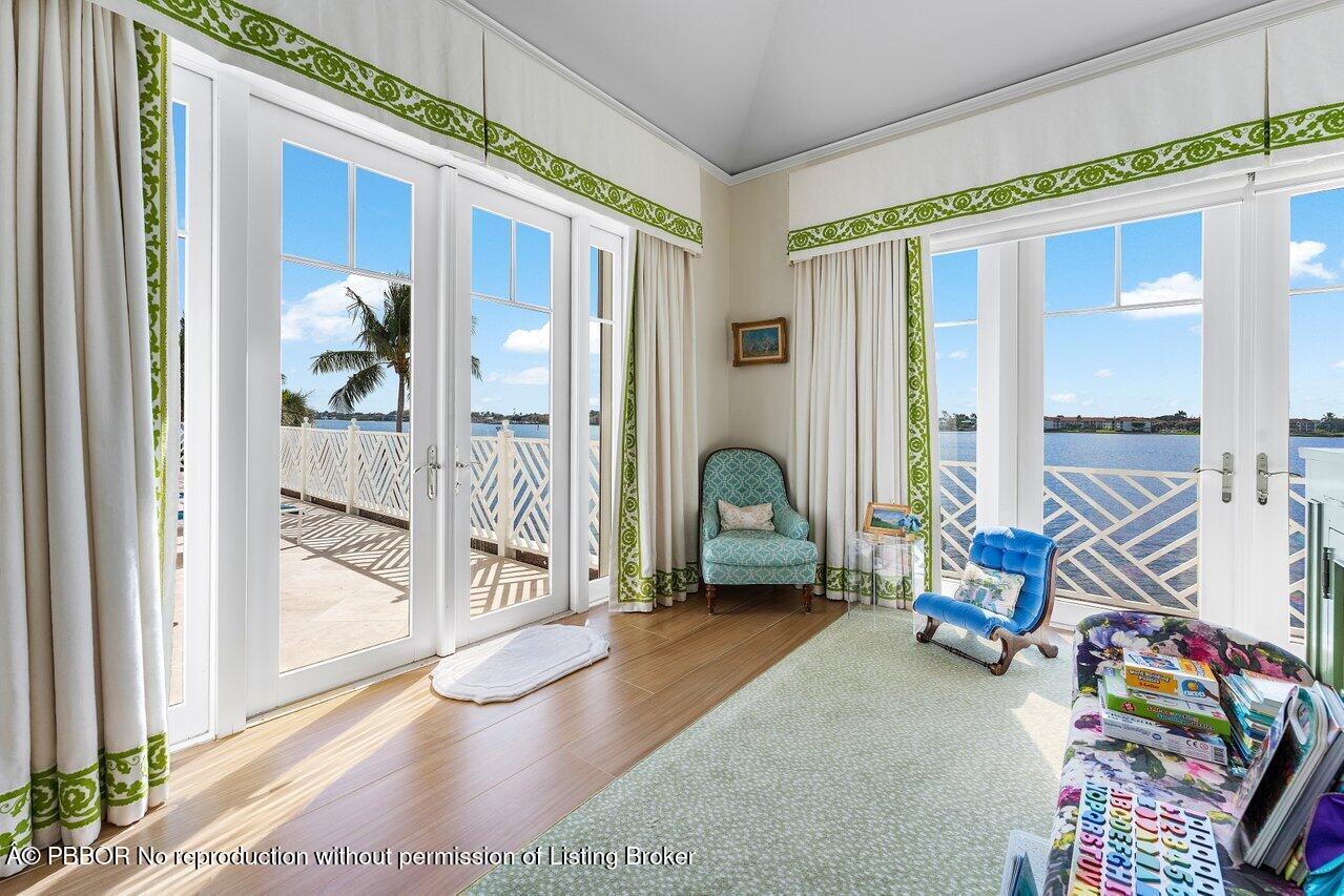 1275 Lands End Road Lake Worth, FL 33462 - Photo 42 of 83 a living room with furniture and a floor to ceiling window