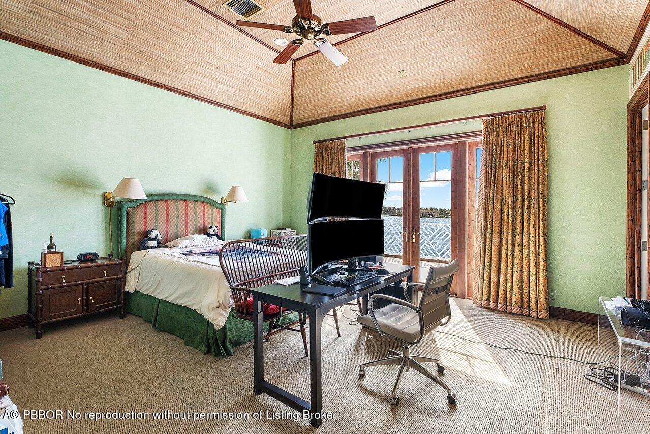1275 Lands End Road Lake Worth, FL 33462 - Photo 43 of 83 a bedroom with a bed and a desk