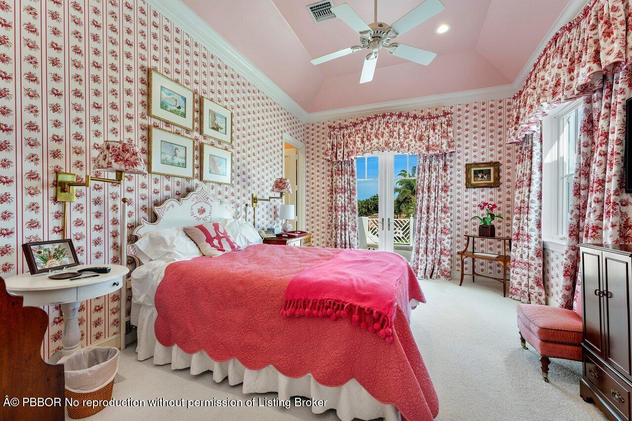 1275 Lands End Road Lake Worth, FL 33462 - Photo 57 of 83 a bedroom with a bed and a chandelier