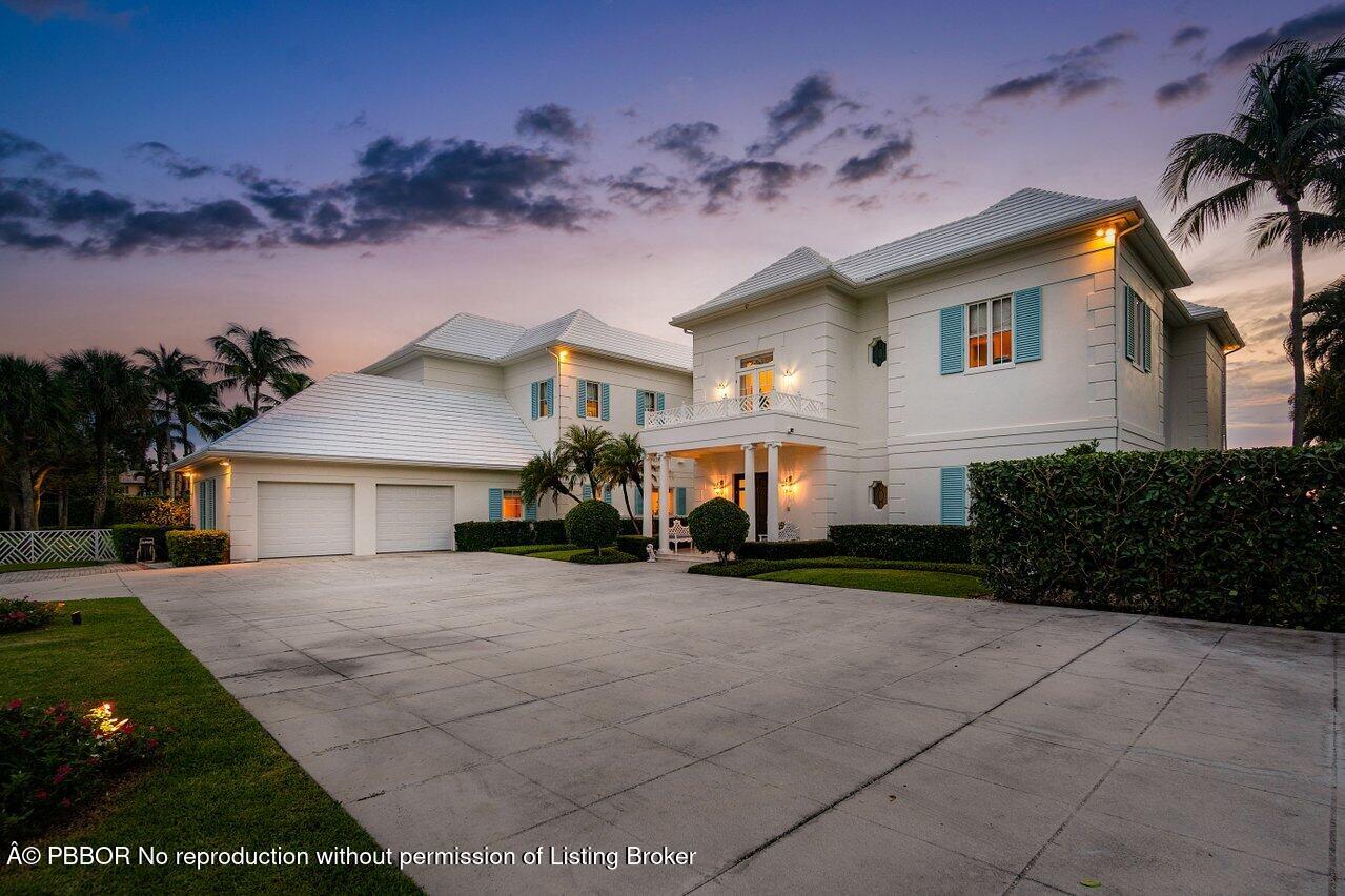 1275 Lands End Road Lake Worth, FL 33462 - Photo 75 of 83 a front view of a house with a yard and garage