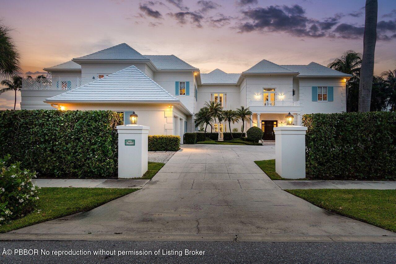 1275 Lands End Road Lake Worth, FL 33462 - Photo 76 of 83 a front view of a house with a yard and garage