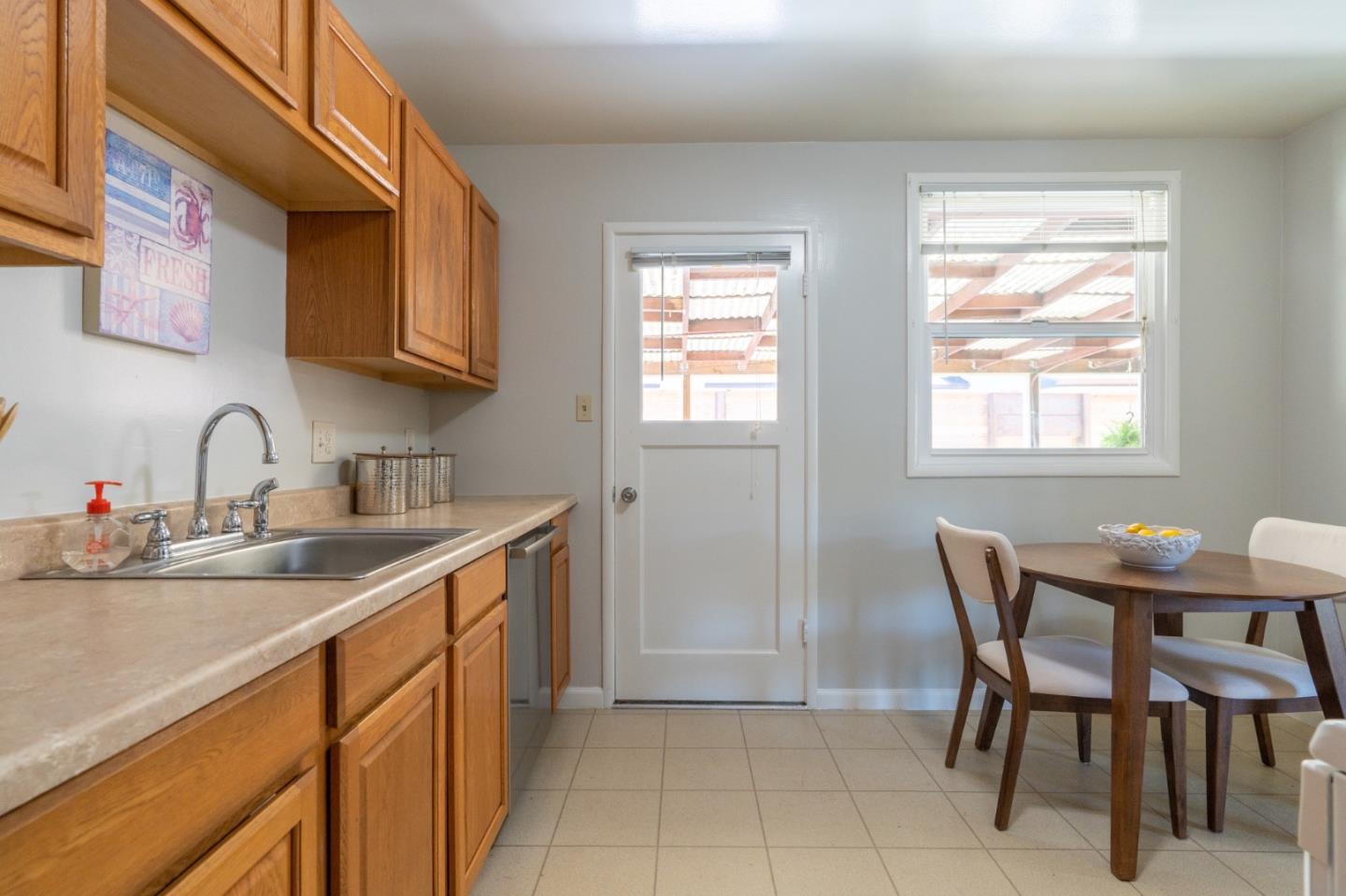 1063 Anza Drive Pacifica, CA 94044 - Photo 9 of 10 a kitchen with stainless steel appliances a sink and cabinets