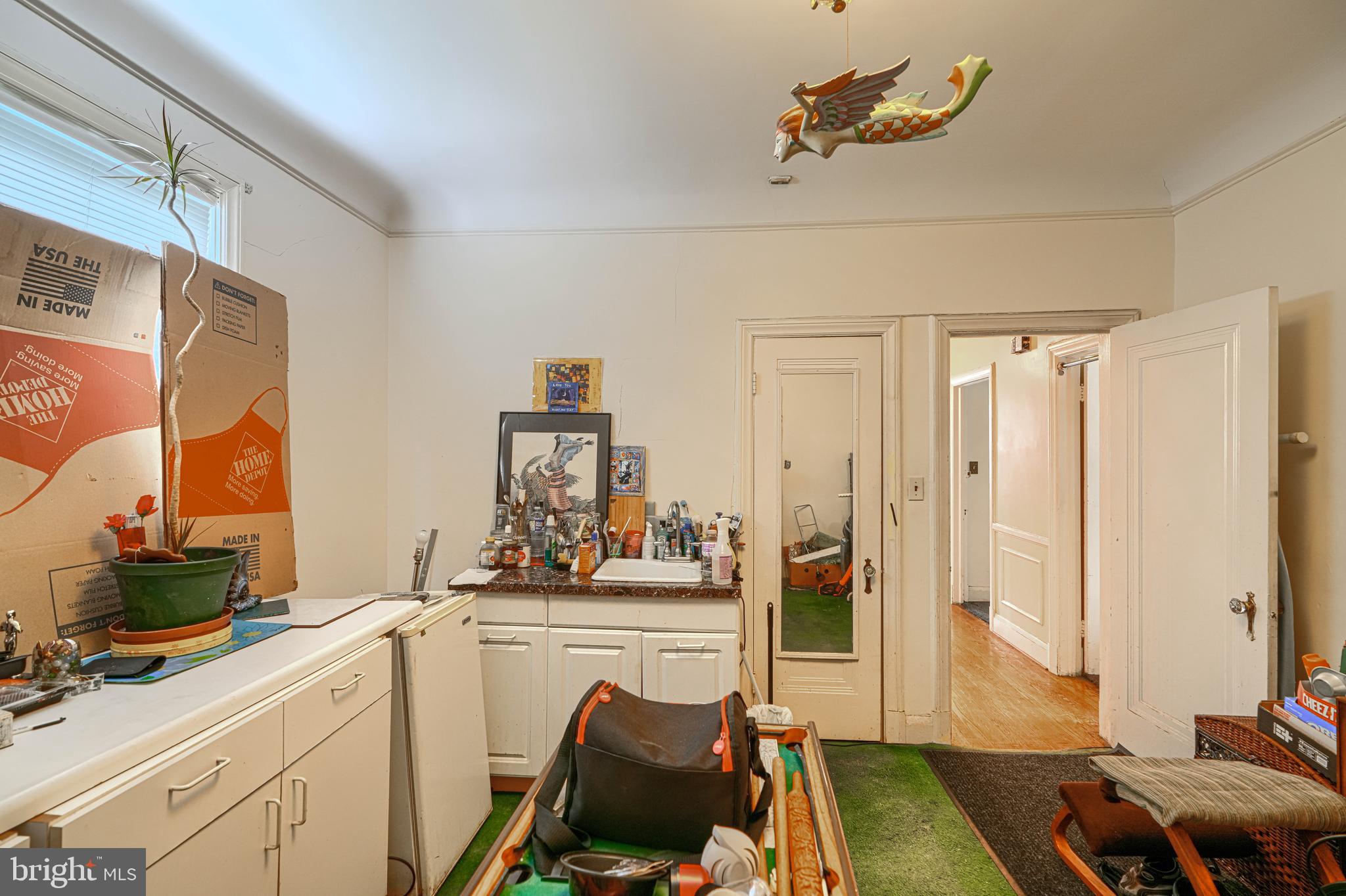 3212 Dorchester Road Baltimore, MD 21215 - Photo 26 of 45 a bedroom with a bed and a chandelier