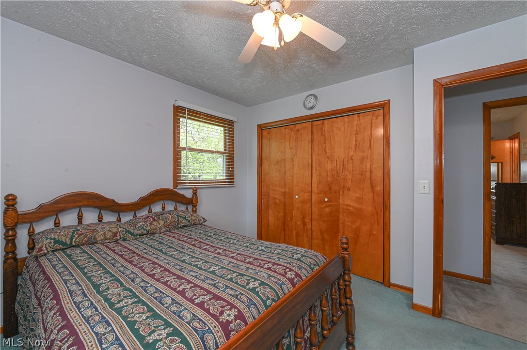 13425 Chardon-Windsor Road Chardon, OH 44024 - Photo 34 of 50 Carpeted bedroom with a closet, ceiling fan, and a textured ceiling
