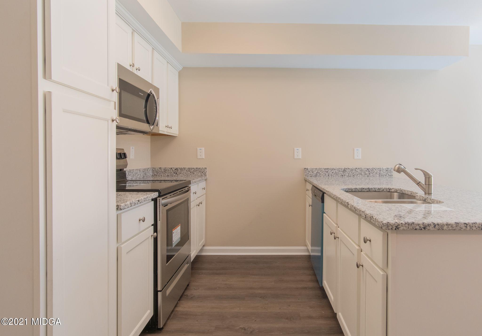340 Pond View Road Macon, GA 31206 - Photo 7 of 22 a kitchen with stainless steel appliances granite countertop a sink and a stove top oven