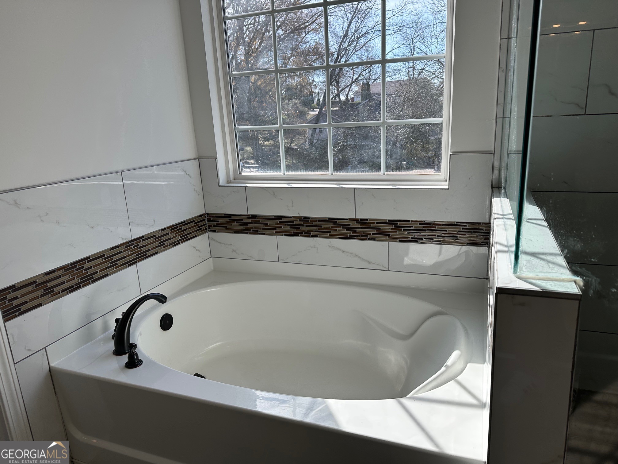 2147 Spring Road Gainesville, GA 30504 - Photo 18 of 44 a bath tub sitting in a bathroom next to a window