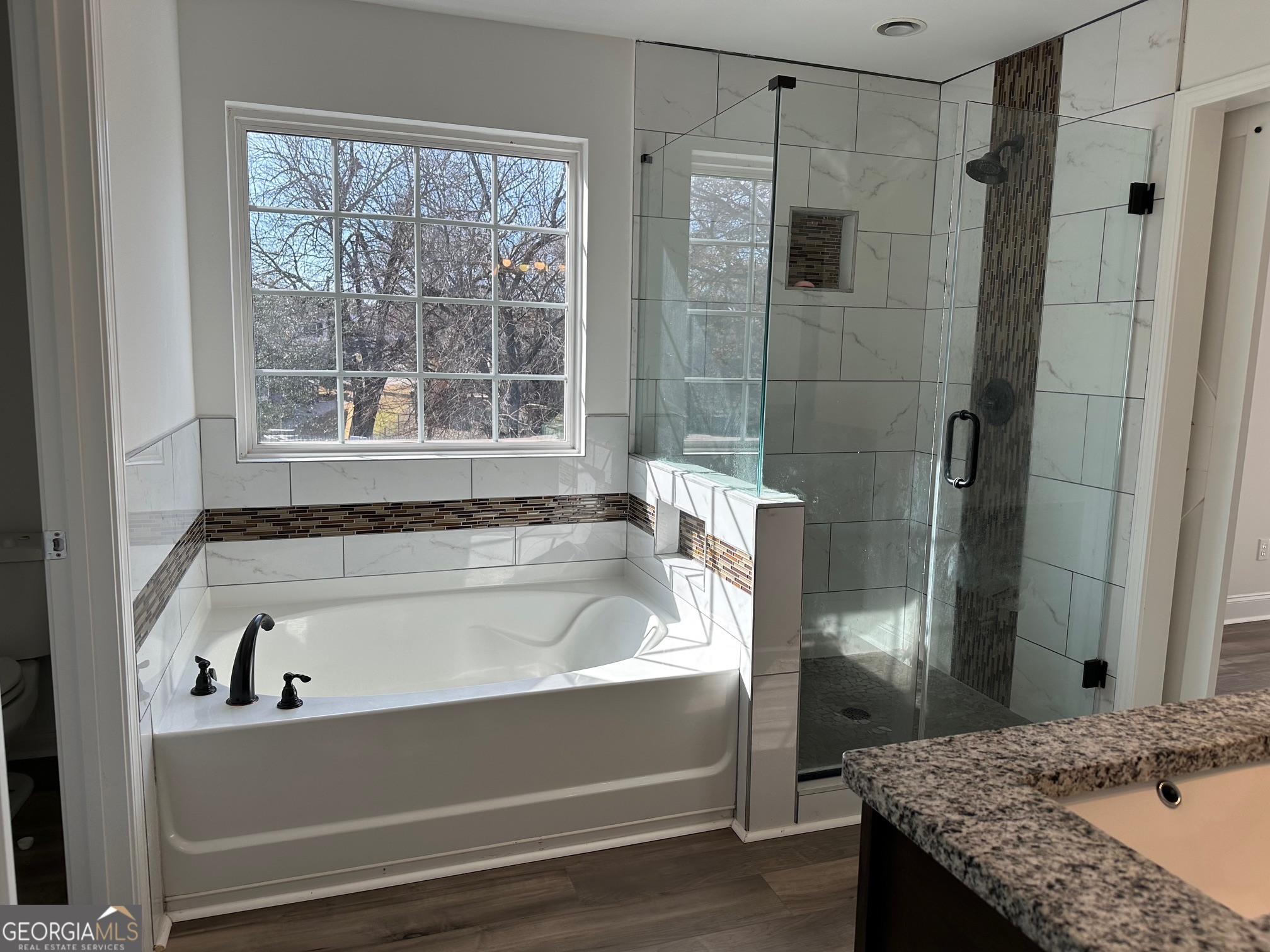 2147 Spring Road Gainesville, GA 30504 - Photo 21 of 44 a bathroom with a tub and a shower