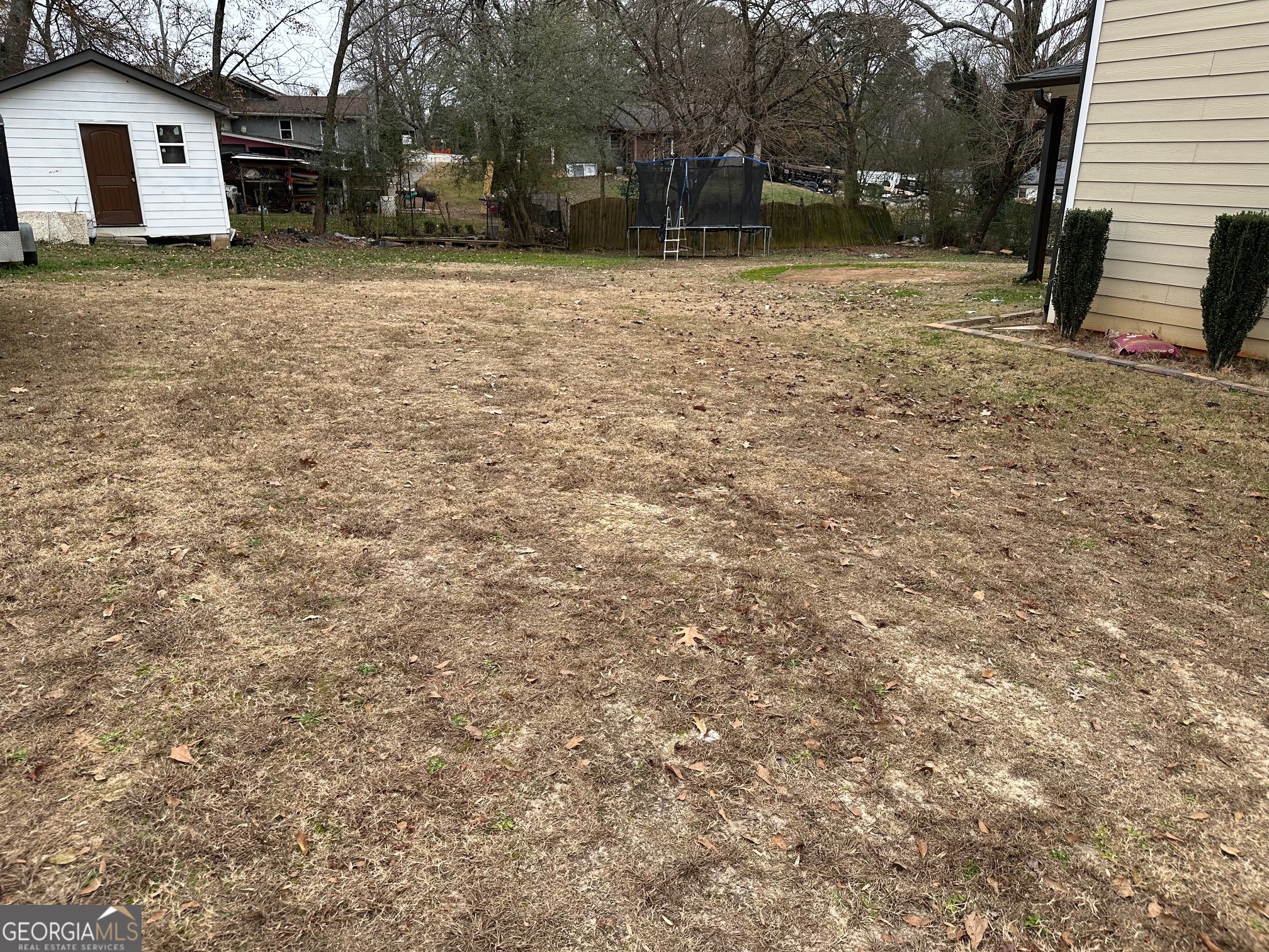 2147 Spring Road Gainesville, GA 30504 - Photo 38 of 44 a backyard of a house with a bench and trees