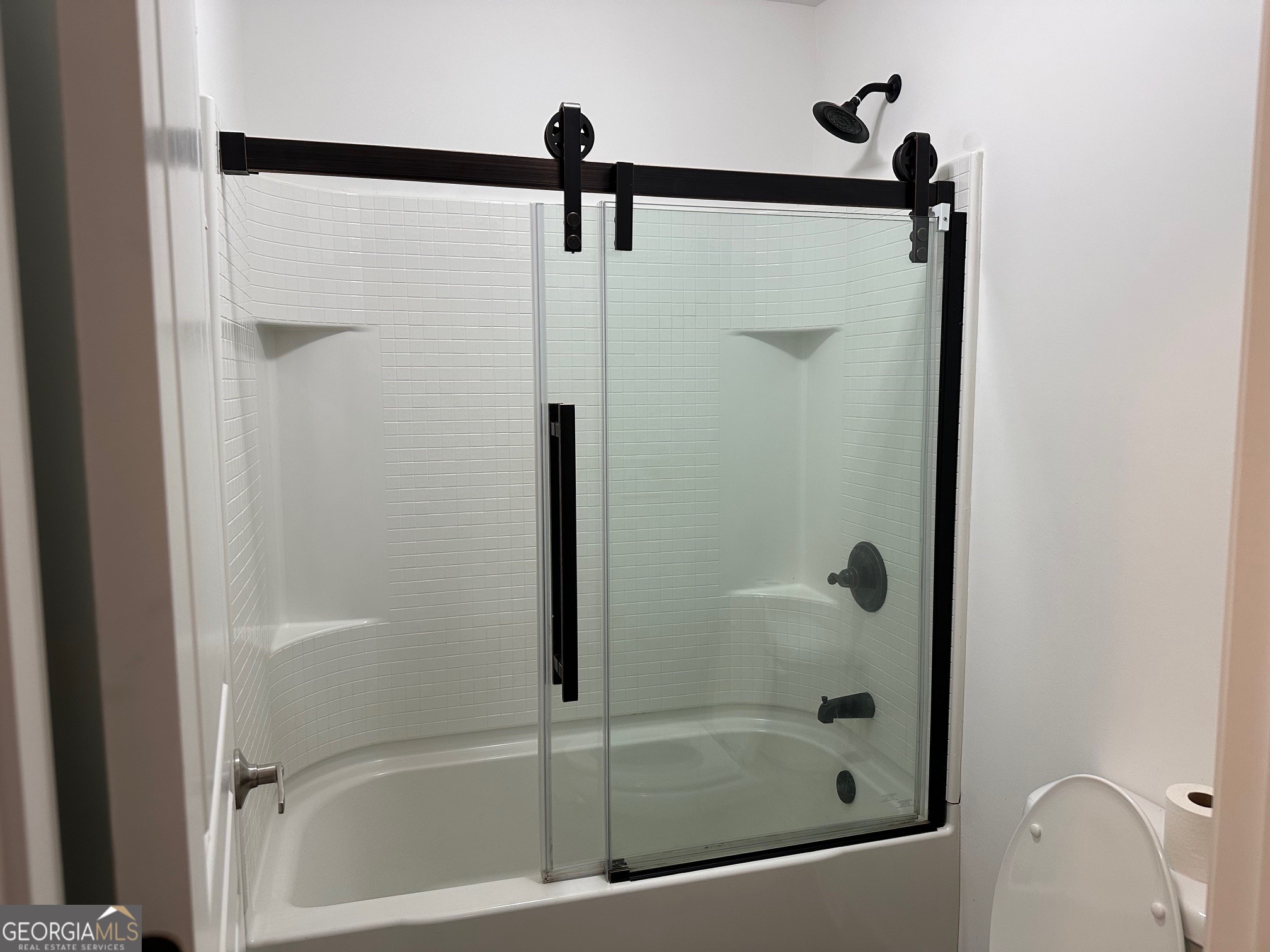 2147 Spring Road Gainesville, GA 30504 - Photo 10 of 44 a bathroom with a shower and a glass door