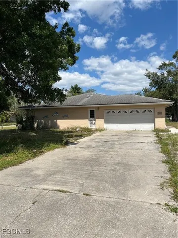 a backyard of a house with yard and barbeque oven