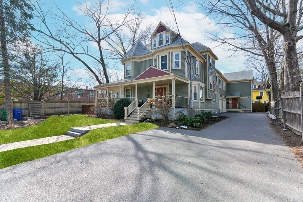 89 Walker Street, Unit 89 Newton, MA 02460 - Photo 1 of 42 a front view of a house with a yard and potted plants