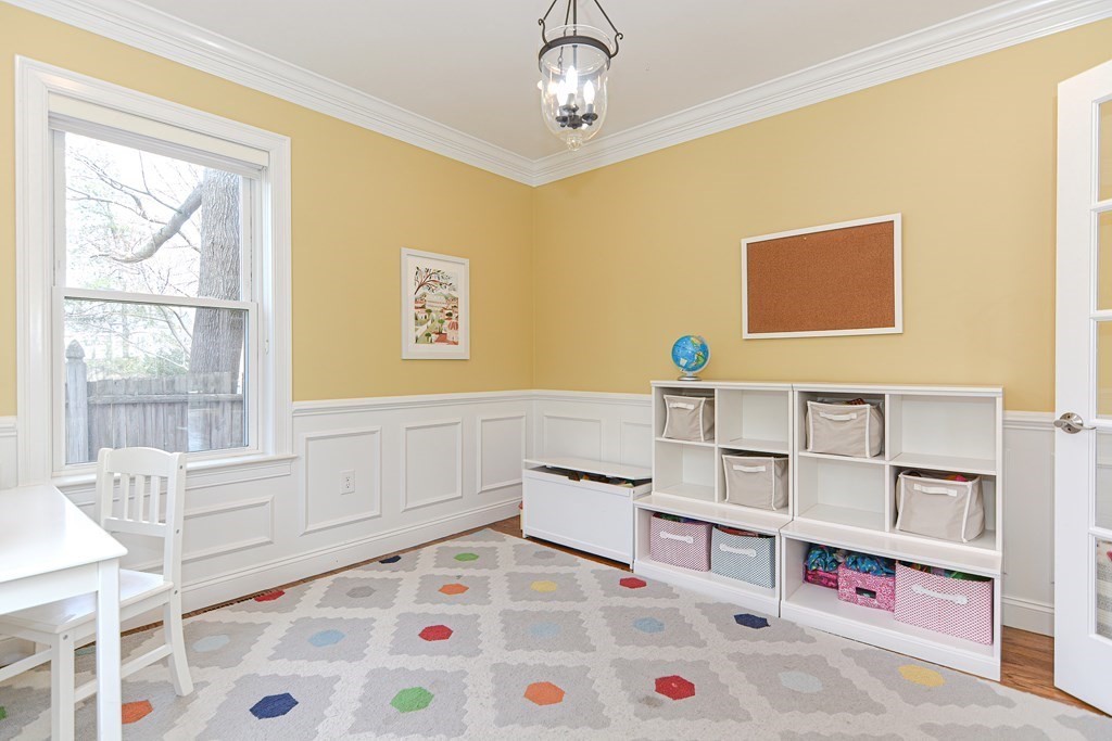89 Walker Street, Unit 89 Newton, MA 02460 - Photo 16 of 42 a bedroom with furniture and a book shelf