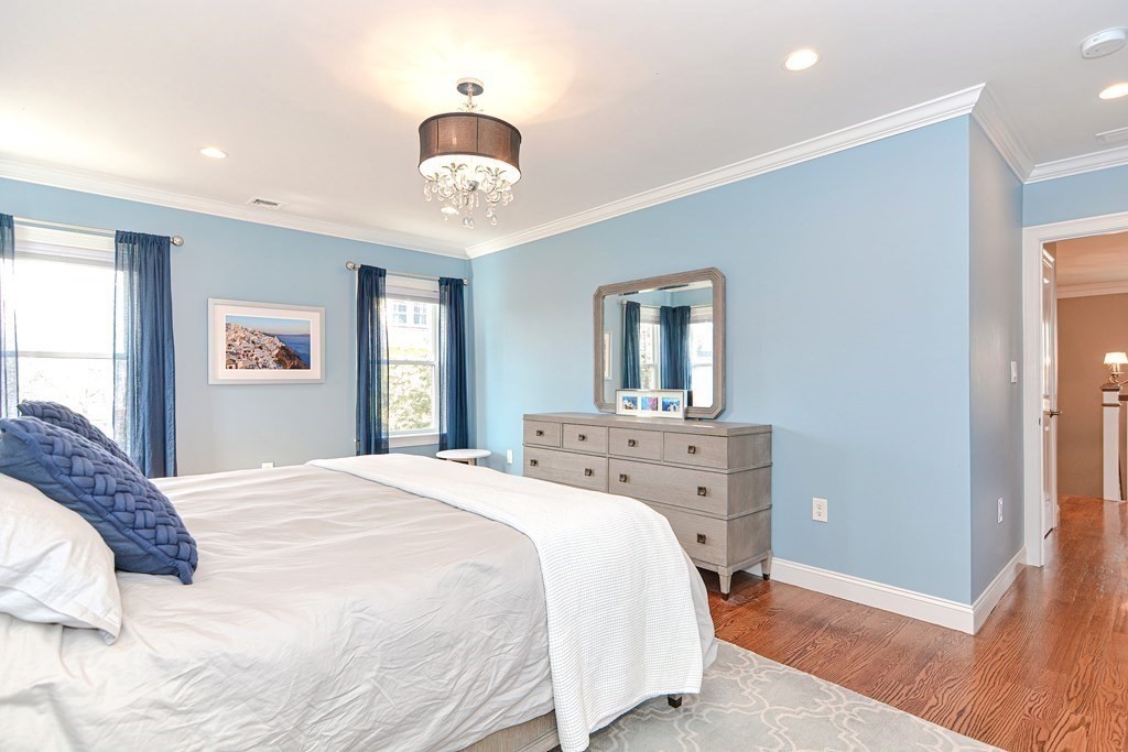 89 Walker Street, Unit 89 Newton, MA 02460 - Photo 20 of 42 a bedroom with a bed and a chandelier