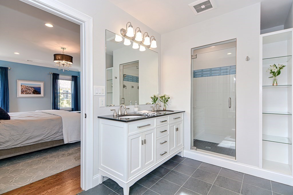 89 Walker Street, Unit 89 Newton, MA 02460 - Photo 21 of 42 a spacious bathroom with a granite countertop sink a mirror and a shower