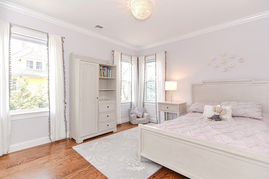 89 Walker Street, Unit 89 Newton, MA 02460 - Photo 22 of 42 a bedroom with a large bed and wooden floor