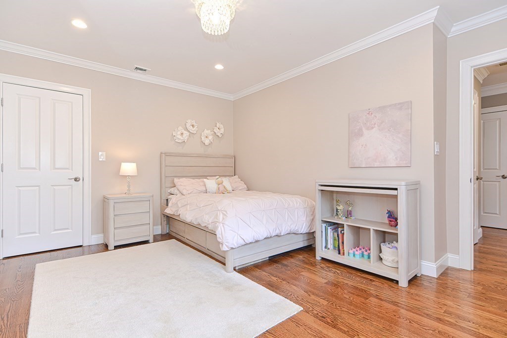 89 Walker Street, Unit 89 Newton, MA 02460 - Photo 23 of 42 a bedroom with a bed and a night stand