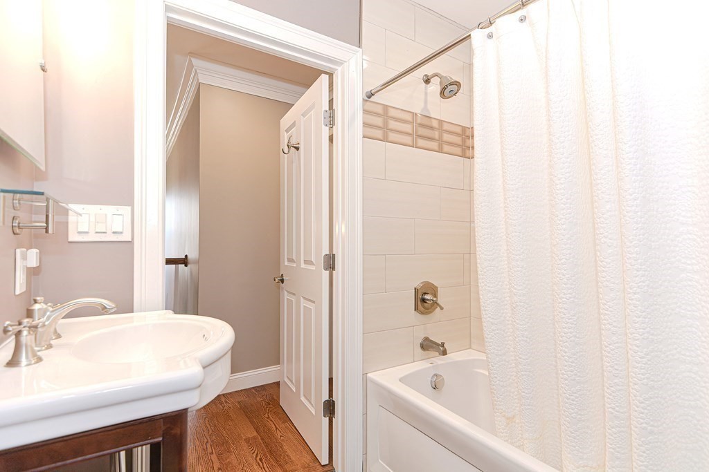 89 Walker Street, Unit 89 Newton, MA 02460 - Photo 27 of 42 a bathroom with a bathtub a sink and a mirror