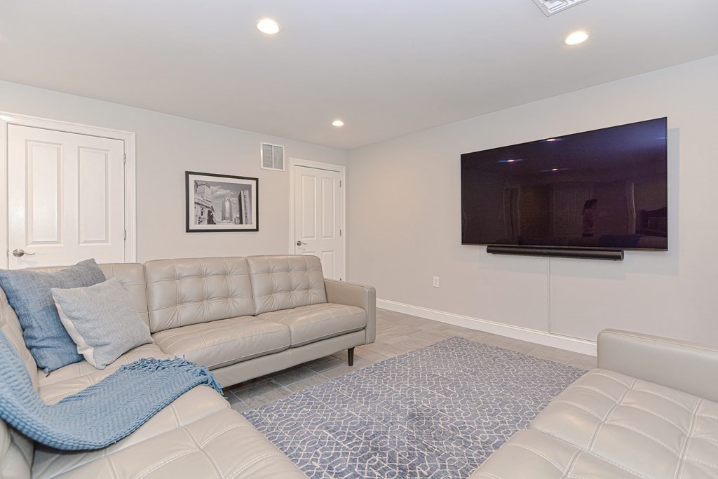 89 Walker Street, Unit 89 Newton, MA 02460 - Photo 28 of 42 a living room with furniture and a flat screen tv
